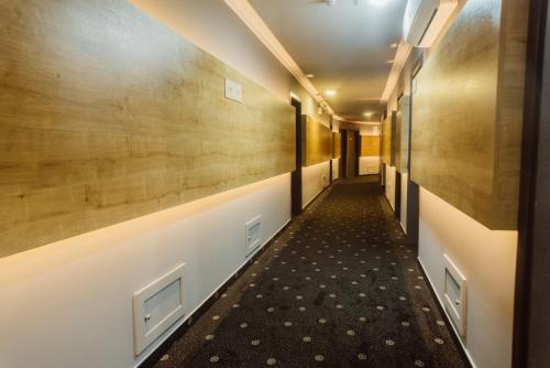 a corridor in a building with wooden walls at Aparthotel Tangerine in Batumi