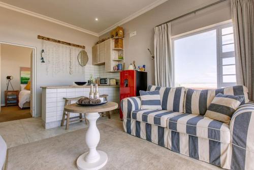 a living room with a couch and a table at Shanalulu Sands - full inverter in Wilderness