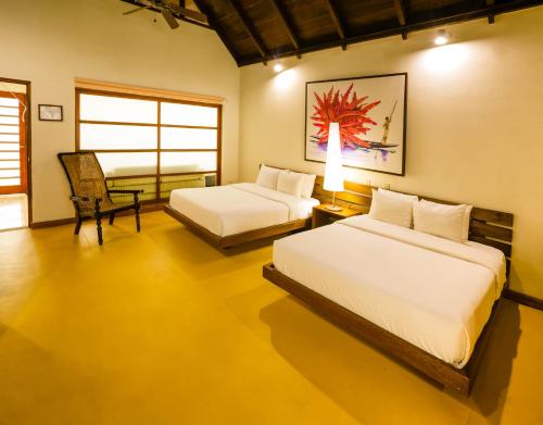 萊蒂西亞的住宿－提卡娜迪若德洛酒店，一间卧室配有两张床和椅子