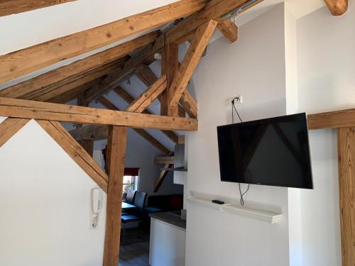 a tv hanging on a wall in a room at Apart Garten Lutz in Prutz