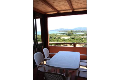 a table and chairs on a balcony with a view at La Mitica 99 del Portolaconia Residence in Cannigione