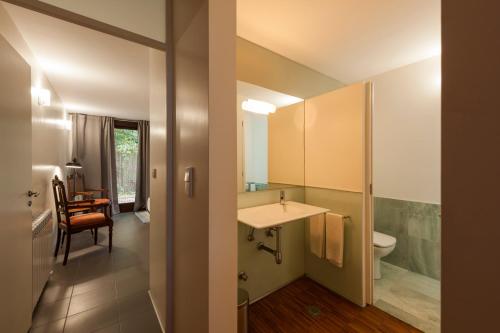 a bathroom with a sink and a toilet at Casa do Sobreiro in Pedroso