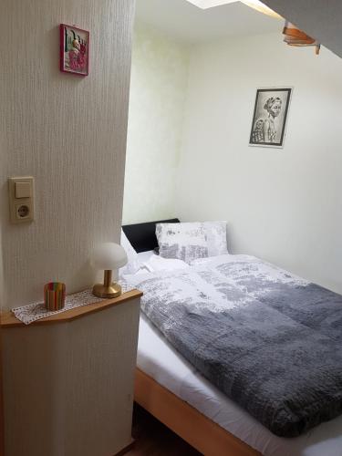 a bedroom with a bed and a table with a lamp at Hartl, Haus in Rauris