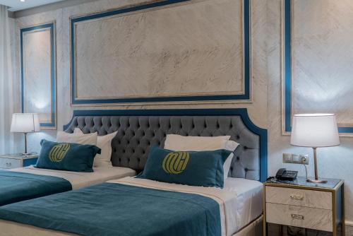a bedroom with two beds with blue and white at Mirart Hotel Boutique & SPA Yalova in Yalova