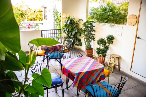 a patio with chairs and a table with an umbrella at Hotel Arbol de Fuego in San Salvador