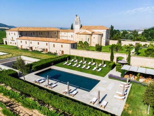 a large building with a large pool of water in front of it at Abadia Retuerta LeDomaine in Sardoncillo