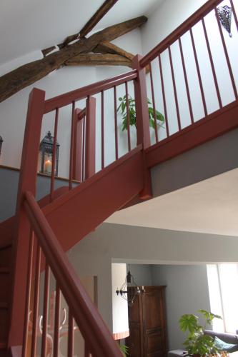 a staircase in a house with a red railing at Domaine de Praline l'ensemble in Villerbon