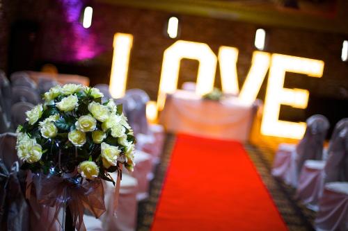 a bouquet of white flowers on a table with chairs at Best Western Plus Lancashire Manor Hotel in Skelmersdale