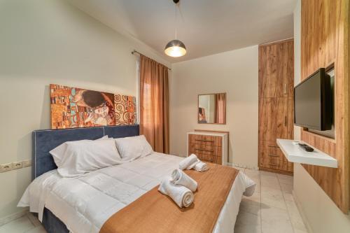 a bedroom with a bed with towels on a wooden table at Amoudara Suites in Amoudara Herakliou
