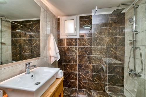 a bathroom with a sink and a shower at Amoudara Suites in Amoudara Herakliou