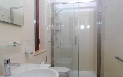 a bathroom with a shower and a toilet and a sink at Villaggio Turistico La Mantinera - Appartamenti de Luxe in Praia a Mare