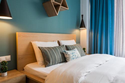 a bed with a white comforter and pillows at Dynasta Central Suites in Athens