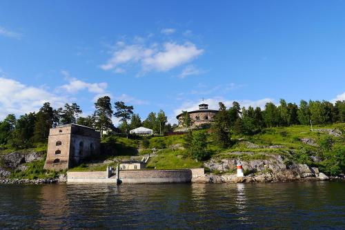 an island in the water with buildings on a hill at Fredriksborg Hotell & Restaurang in Värmdö