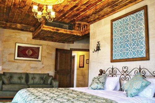 a bedroom with a bed and a couch at Caravanserai Inn Hotel in Goreme