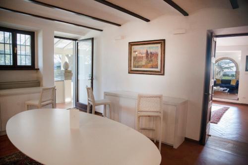 a white table and chairs in a room at Villa I Barronci Resort & Spa in San Casciano in Val di Pesa