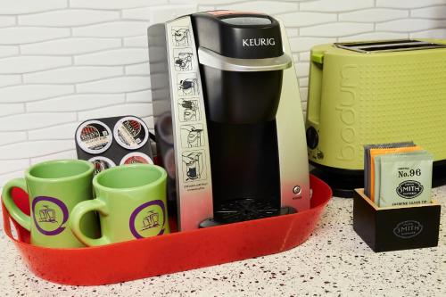 a tray with cups and a coffee maker on a counter at Inn at Northrup Station in Portland