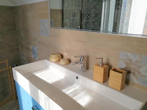 a bathroom with a white sink and a mirror at La Corte dell'Angelo in Orio al Serio