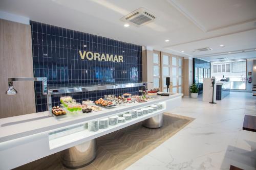 a vendar buffet in a hotel lobby with food at Hotel Voramar in Benidorm