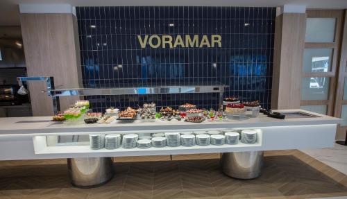 a display case in a store with a table of food at Hotel Voramar in Benidorm