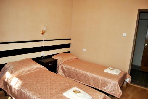 Una cama o camas en una habitación de Elegia Hotel