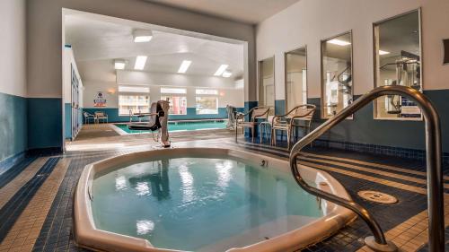 a swimming pool with a jacuzzi tub in a gym at Best Western Salbasgeon Inn & Suites in Reedsport