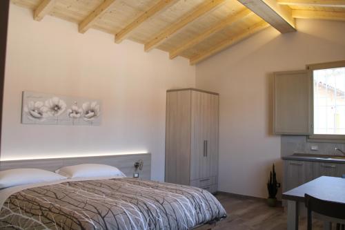 a bedroom with a bed and a wooden ceiling at Agriturismo Ravaglia Grande in Castel Guelfo di Bologna