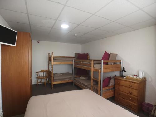 a bedroom with two bunk beds and a desk at The Hopton Hotel in Blackpool