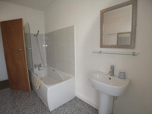 a bathroom with a sink and a bath tub and a sink at The Hopton Hotel in Blackpool
