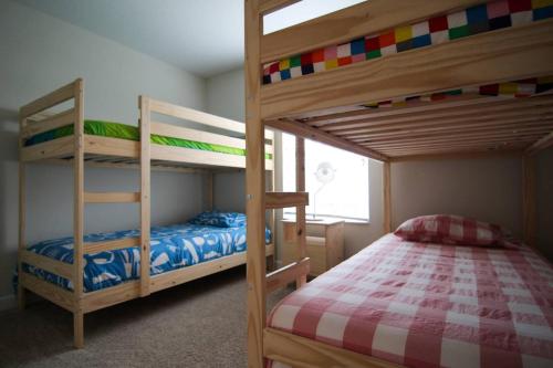 a bedroom with two bunk beds and a bed at A - New 4 Bedroom Home - 5 Miles to Disney - Free Water Park - Private Pool in Kissimmee