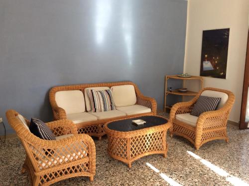 a living room with wicker chairs and a couch at Il Casalino in Maratea