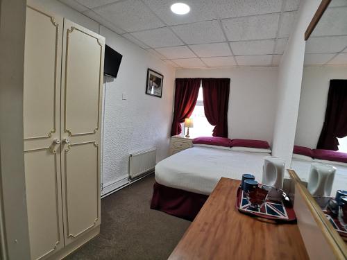 a hotel room with a bed and a table and a table sidx sidx at The Hopton Hotel in Blackpool