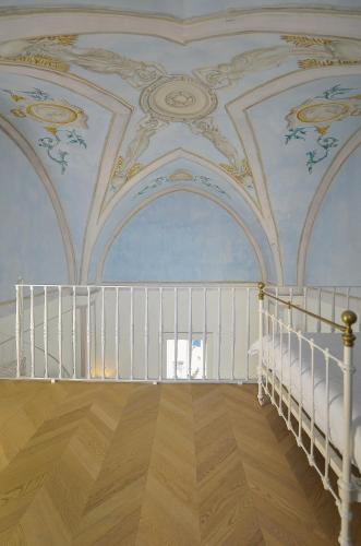 a room with a staircase and a ceiling with paintings at Relais Monastero Santa Teresa - Albergo Diffuso in Nardò