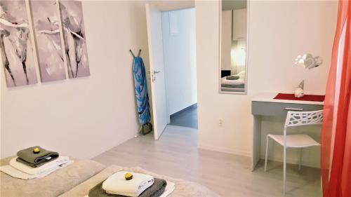 a room with a desk and a table with a chair at Apartmani "Sandro" Gonar in Rab