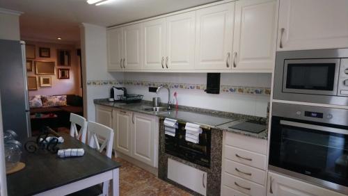 a kitchen with white cabinets and a counter top at los Balcones de Nieda in Cangas de Onís
