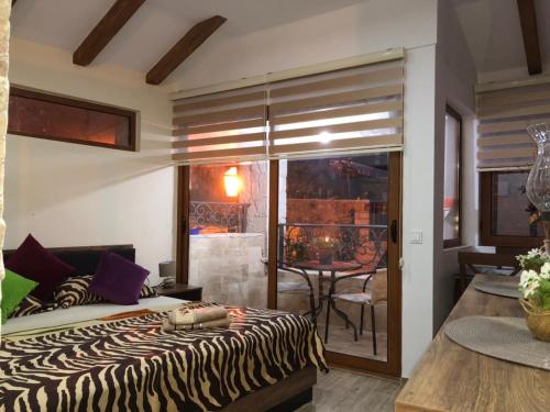 a zebra print bed in a room with a table at Apartments Antigona Old Town in Ulcinj