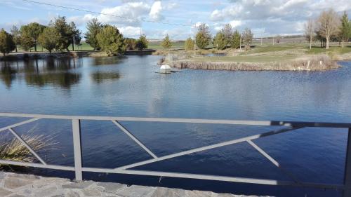 a view of a pond with a white object in the water at Las Casas de Pecheye in Bocigas