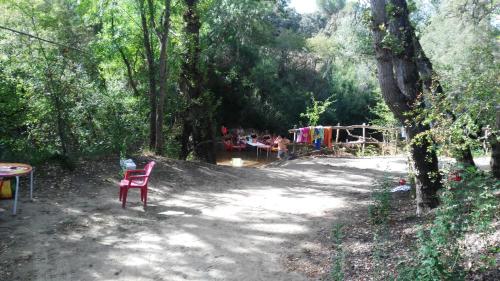 a red chair sitting in the middle of a dirt road at Las Casas de Pecheye in Bocigas