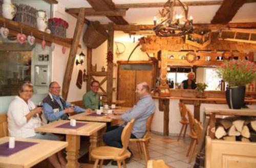 a man sitting at a table in a restaurant at Hotel Garni Kaiserpfalz in Goslar