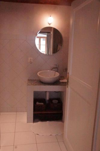 a bathroom with a sink and a mirror at Maison Junod in Romainmôtier