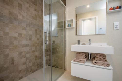 a bathroom with a sink and a shower at Urbano Blanco Apartments in Calpe
