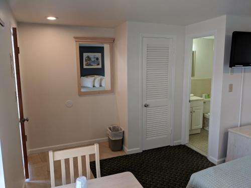 a room with a bathroom with a bed and a sink at Crystal Sands Motel in Ocean City