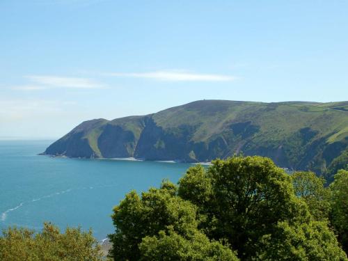 a view of a large body of water with mountains at Chough's Nest Hotel in Lynton