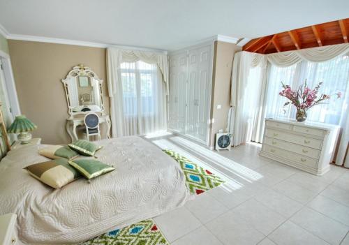 a large bedroom with a large bed and a dresser at Villa Lemon in Adeje