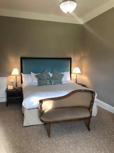 a bedroom with a large bed and two lamps at Coul House Hotel in Contin