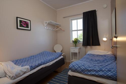 a bedroom with two beds and a window at STF Bunge Hostel in Fårösund
