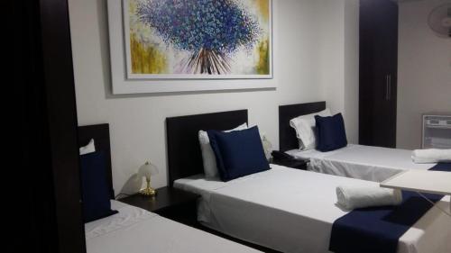 Postel nebo postele na pokoji v ubytování Hotel Girón Plaza
