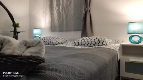 a bedroom with a bed with pillows and two lamps at SMARAGD RIVER near Rastoke & Plitvice Lakes in Slunj