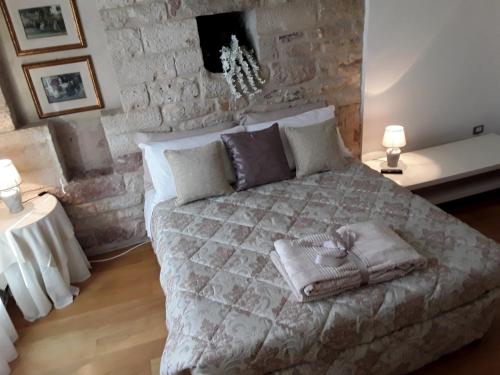 a bedroom with a large bed with pillows on it at Case Brizi 10 in Assisi