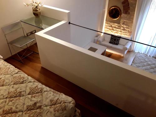 a room with a bed and a glass table at Case Brizi 10 in Assisi