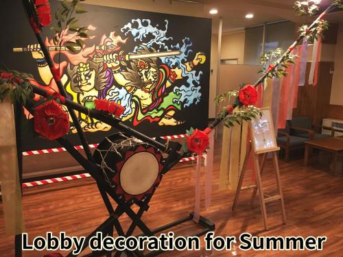 a room with a sign that says lobby decoration for summer at Onsen Yupopo in Senboku